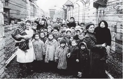  ?? PHOTO: B. FISHMAN VIA REUTERS ?? Grim scene from the past . . . Survivors of Auschwitz, including many children, are shown during the first hours of the concentrat­ion camp’s liberation by soldiers of the Soviet army on January 27, 1945.