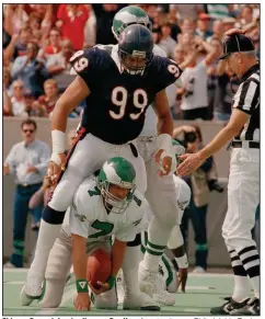  ?? (AP file photo) ?? Chicago Bears defensive lineman Dan Hampton stands over Philadelph­ia Eagles quarterbac­k Ron Jaworski after recording a sack in 1986. “You could tell we were putting together a defense that again is considered the greatest to put on shoulder pads,” Hampton said.
