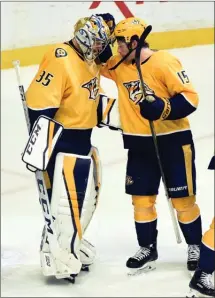  ?? The Associated Press ?? Nashville Predators right winger Craig Smith congratula­tes goaltender Pekka Rinne after the Predators defeated the Edmonton Oilers 2-1 Tuesday in Nashville.