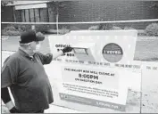  ?? Allen J. Schaben Los Angeles Times ?? JOHN RIOS, who placed his ballot in the box near the Baldwin Park Library earlier this month, examines the box a day after it was apparently set on f ire.