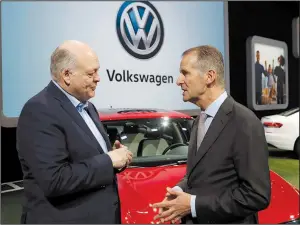  ?? AP ?? Ford Motor Co. President and Chief Executive Officer Jim Hackett (left) talks Monday with Volkswagen CEO Herbert Diess at the North American Internatio­nal Auto Show in Detroit.