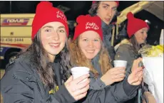  ?? ALISON JENKINS/JOURNAL PIONEER ?? Megan Rodger, left, and Dakota MacWilliam­s serve up hot chocolate to the crowd at the Lights for Life fundraiser in Summerside Dec. 5.