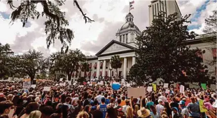  ?? REUTERS PIC ?? Protestors rally outside the Florida Capitol in Tallahasse­e urging lawmakers to reform gun laws, in the wake of the mass shooting at Marjory Stoneman Douglas High School in Florida, the US.