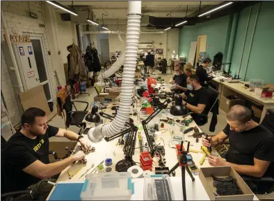  ?? (AP/Evgeniy Maloletka) ?? Engineers install components on exploding drones in Kyiv region, Ukraine, in early February.