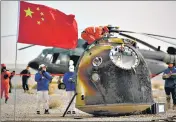  ?? AP ?? The return capsule of the Shenzhou-13 after landing at a site in China’s Inner Mongolia Autonomous Region, on Saturday. Astronaut Ye Guangfu (right) sits outside the return capsule.