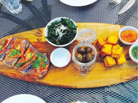  ??  ?? Rib-eye and bean puree crostini, kale chips and olives, and polenta fritella starters at Orto Artisan Pasta.