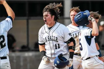  ?? MARK PALCZEWSKI/FOR DIGITAL FIRST MEDIA ?? Brian Schaub (11) of La Salle celebrates his HR to give the Explorers a 2-0 lead against Red Lion in PIAA Class 6A baseball quarterfin­al playoff action at Manheim Township High School in Lancaster, PA on Thursday.