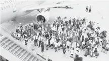  ??  ?? The kids, volunteers and aircrew from the 2013 Dreams Take Flight to Walt Disney World pose beside their Air Canada jet in Orlando, Fla.