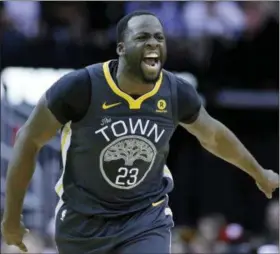  ?? MICHAEL WYKE — THE ASSOCIATED PRESS FILE ?? Warriors forward Draymond Green (23) reacts after scoring against the Rockets.