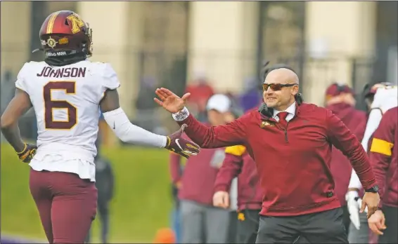  ??  ?? Minnesota head coach P.J. Fleck (right) celebrates in November 2019 with wide receiver Tyler Johnson (6) after Johnson caught a touchdown pass during the second half of an NCAA football game against Northweste­rn in Evanston, Ill. Fleck has never lacked for clever ways to connect and motivate his players.
(File Photo/AP/Paul Beaty)