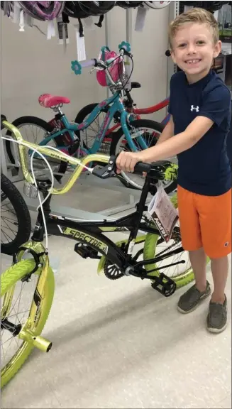  ?? COURTESY PHOTO ?? Braxton Mcintyre stands next to the bicycle he selected in 2019as part of the Bikes for Kids program, sponsored by Barberi Law. The program returns this year after a two-year hiatus due to COVID-19.