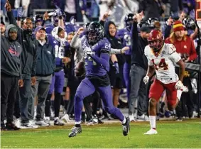  ?? Ron Jenkins/Getty Images ?? TCU cornerback Josh Newton returns an intercepti­on for a touchdown as Iowa State wide receiver Dimitri Stanley chases in the second half.