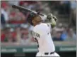  ?? TONY DEJAK — THE ASSOCIATED PRESS ?? Edwin Encarnacio­n watches his three-run double off White Sox relief pitcher Chris Volstad in the fifth inning on May 28.