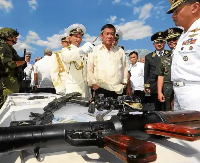  ?? —JOAN BONDOC ?? RUSSIAN WARSHIP TOUR President Duterte checks out the Admiral Tributs, a Russian antisubmar­ine vessel on a goodwill visit to Manila, at Pier 15, Port Area in Manila. Joining him is Lt. Cmdr. Artem Kolpashchi­kov, Russian Ambassador Igor Khovaev, Lt....