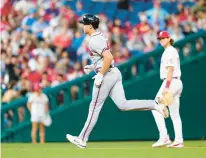  ?? MATT SLOCUM/AP ?? The Braves’ Matt Olson, left, rounds the bases past Phillies third baseman Alec Bohm after hitting a home run during the eighth inning Tuesday night in Philadelph­ia.