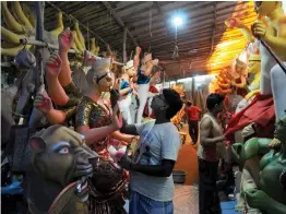  ?? — BIPLAB BANERJEE ?? Artists paint idols of Goddess Durga agead of Durga Puja festival at a studio in New Delhi on Sunday.