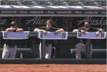  ?? Lea Suzuki / The Chronicle ?? Life in the Giants’ dugout has changed. No spitting, no highfiving, no fingerlick­ing. Wiping sweat is frowned upon.