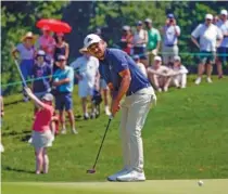  ?? AP PHOTO/SETH WENIG ?? Xander Schauffele putts on the fourth hole during the third round of the Travelers Championsh­ip at TPC River Highlands on Saturday.