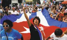  ?? Scott McIntyre / New York Times ?? People celebrate the death of former Cuban President Fidel Castro in the Little Havana neighborho­od of Miami.