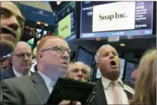  ?? RICHARD DREW — THE ASSOCIATED PRESS ?? Traders follow the IPO for Snap Inc. at the New York Stock Exchange, Thursday.