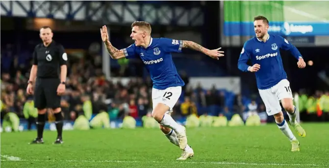  ?? — Reuters ?? Bullseye!: Everton’s Lucas Digne (centre) celebratin­g after scoring the second goal against Watford.