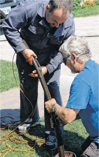  ?? ROBERT MAXWELL ?? Lifting out the old pipe and pump is the most challengin­g part of repairing a failed submersibl­e water well pump installati­on.