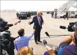  ?? Andrew Harnik Associated Press ?? PRESIDENT Trump speaks to reporters at Sacramento McClellan Airport on Monday. At a briefing with officials, he questioned the science on climate change.