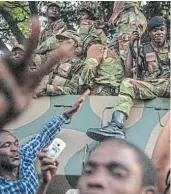  ?? Picture: GETTY IMAGES ?? THAT WAS THEN: People celebrate with soldiers on a tank in the streets of Harare, after the resignatio­n of Robert Mugabe on November 21 2017.