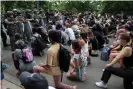  ?? Photograph: Jonathan Ernst/Reuters ?? Demonstrat­ors take a knee in front of law enforcemen­t officers during a protest against the death of George Floyd, near the White House on 3 June.