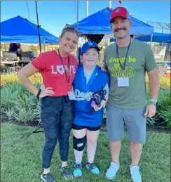  ?? Courtesy Miracle League of the South Hills ?? Macee Peterson, of South Park, worked her way back from a knee injury and starred for the Dodgers during the Miracle League All-Star Game on Nov. 6. Also pictured are Miranda Klein and Tim Gebhart, the assistant director and executive director of the Miracle League of the South Hills.