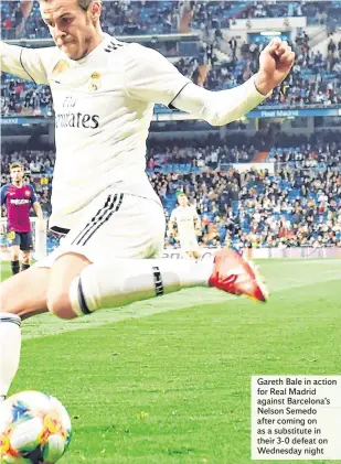  ??  ?? Gareth Bale in action for Real Madrid against Barcelona’s Nelson Semedo after coming on as a substitute in their 3-0 defeat on Wednesday night