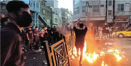  ?? ?? People light a fire during a protest over the death of Mahsa Amini, a woman who died after being arrested by the Islamic republic's ‘morality police’ in Tehran, Iran. /West Asia News Agency via REUTERS