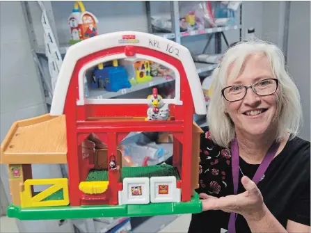  ?? PETER LEE WATERLOO REGION RECORD ?? Library employee Karen Wylie with one of the 126 toys and 50 puzzles available to take home and try out.