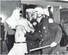  ?? AP ?? Chicago police lead a demonstrat­or down Michigan Avenue on Aug. 28, 1968, in Chicago.