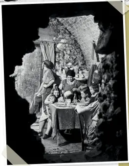  ??  ?? LEFT A family eating dinner in the shattered remains of their cellar. October 1940