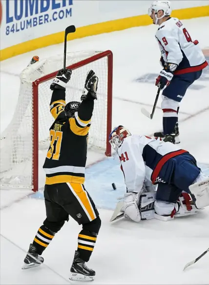  ?? Peter Diana/Post-Gazette ?? Sidney Crosby celebrates his winning goal in overtime Tuesday. He beat Capitals goalie Vitek Vanecek to give the Penguins a 5-4 victory against Washington at PPG Paints Arena.