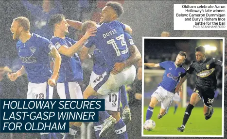  ??  ?? Oldham celebrate Aaron Holloway’s late winner. Below: Cameron Dummigan and Bury’s Roham Ince battle for the ball