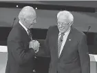  ?? SCOTT OLSON/ GETTY IMAGES ?? Former Vice President Joe Biden, left, greets Sen. Bernie Sanders before the Democratic presidenti­al primary debate at Drake University on Jan. 14 in Des Moines, Iowa.