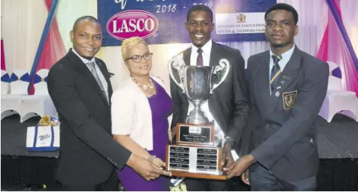  ??  ?? Principal of Munro College Mark Smith (left), vice-principal Ann Marie Powell (second left), and Munro College student Johari Forrest (right) celebrate the success of their senior teacher Amorkard Brown, who copped the 2018-19 LASCO Ministry of Education Youth &amp; Informatio­n Teacher of the Year title.