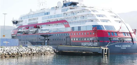  ??  ?? Norwegian cruise ship MS Roald Amundsen is moored in Tromso, Norway, on Monday. About 40 people on the vessel were tested positive for the coronaviru­s.