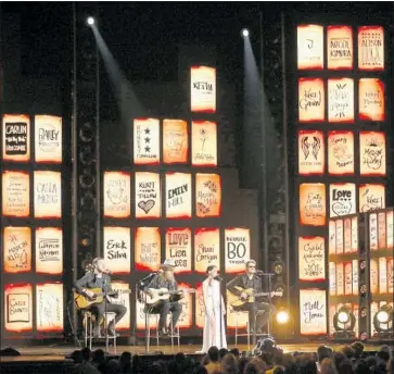  ?? Matt Sayles Invision/AP ?? THE BROTHERS OSBORNE, from left, Maren Morris and Eric Church perform in front of victims’ names.