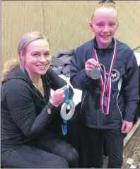  ?? SUBMITTED ?? Two-time Olympian and world championsh­ip silver medallist Ellie Black, left, was a visitor to the Prince Edward Classic last weekend in Charlottet­own. She presented Victoria Covey, of the Island Gymnastics Academy, her silver medal following the tyro 8...