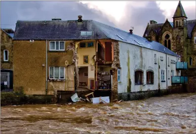  ?? Picture: PA ?? Part of the Bridge House Guest House and Sonia’s Bistro in Hawick collapsed into the fast-flowing River Teviot as Storm Ciara battered Scotland with high winds and heavy rain.