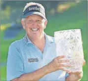  ?? [KYODO NEWS VIA AP] ?? Colin Montgomeri­e poses with the trophy Sunday after winning the Japan Airlines Championsh­ip, the first PGA Tour Champions event in Japan, in Chiba, near Tokyo.