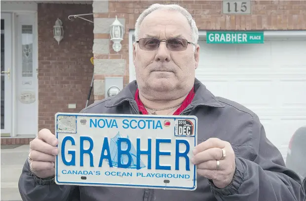  ?? ANDREW VAUGHAN / THE CANADIAN PRESS ?? Lorne Grabher, a Nova Scotia retiree, displays his personaliz­ed licence plate in Dartmouth, N. S., earlier this year.