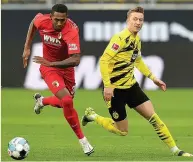 ??  ?? IN HIS STRIDE Oxford takes on Dortmund star Reus