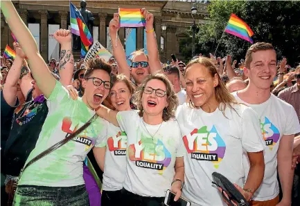  ?? PHOTO: GETTY IMAGES ?? Supporters of same-sex marriage celebrate outside the State Library in Melbourne after the result of the postal survey - a 61.6 per cent ‘‘yes’’ vote - is announced. Australia’s federal parliament is set to debate a law change.