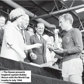  ?? ?? The Queen presents England captain Bobby Moore with the World Cup trophy in July 1966