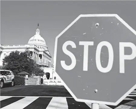  ?? ANDREW CABALLERO-REYNOLDS/GETTY-AFP ?? The U.S. Capitol in Washington, D.C., is seen as the government shutdown entered its sixth day Thursday.