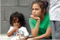  ?? AP ?? Angui Funes, right, sits with her brother, Jesus, after crossing the border back to Reynosa, Mexico. —